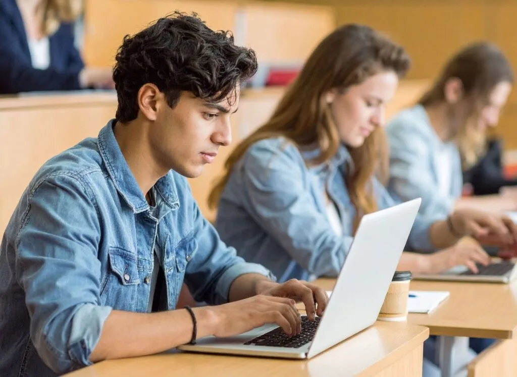 Young person using a laptop for study