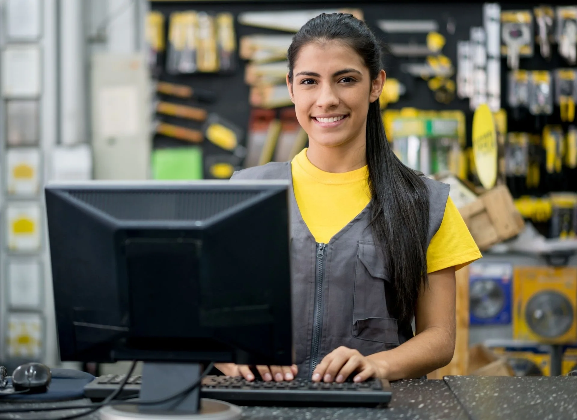 A lady in hardware shop on till