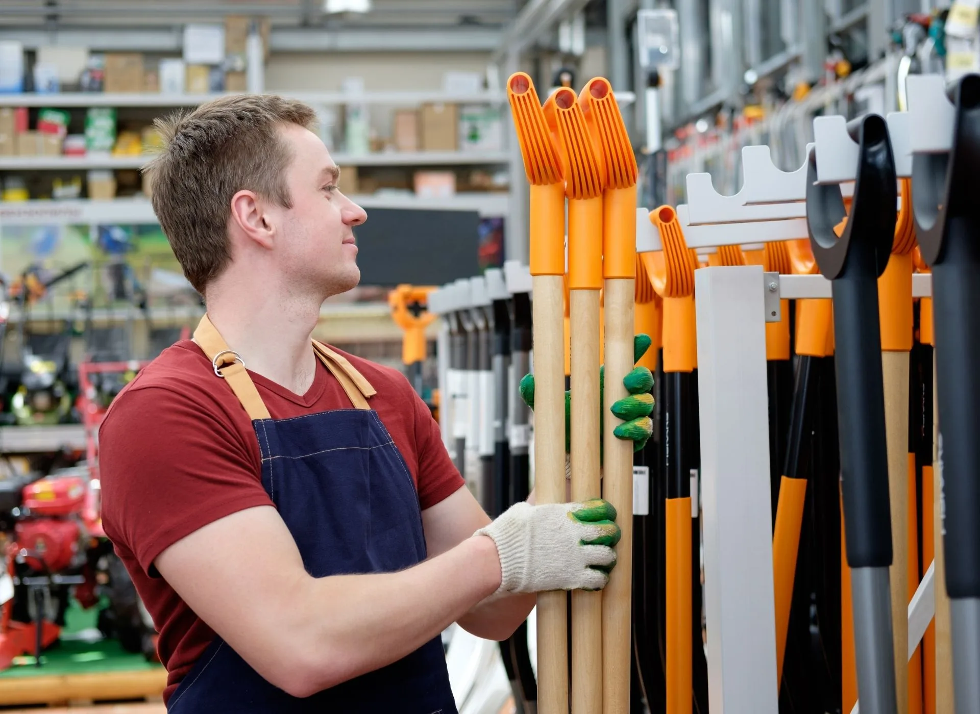 A man in diy shop with garden tools