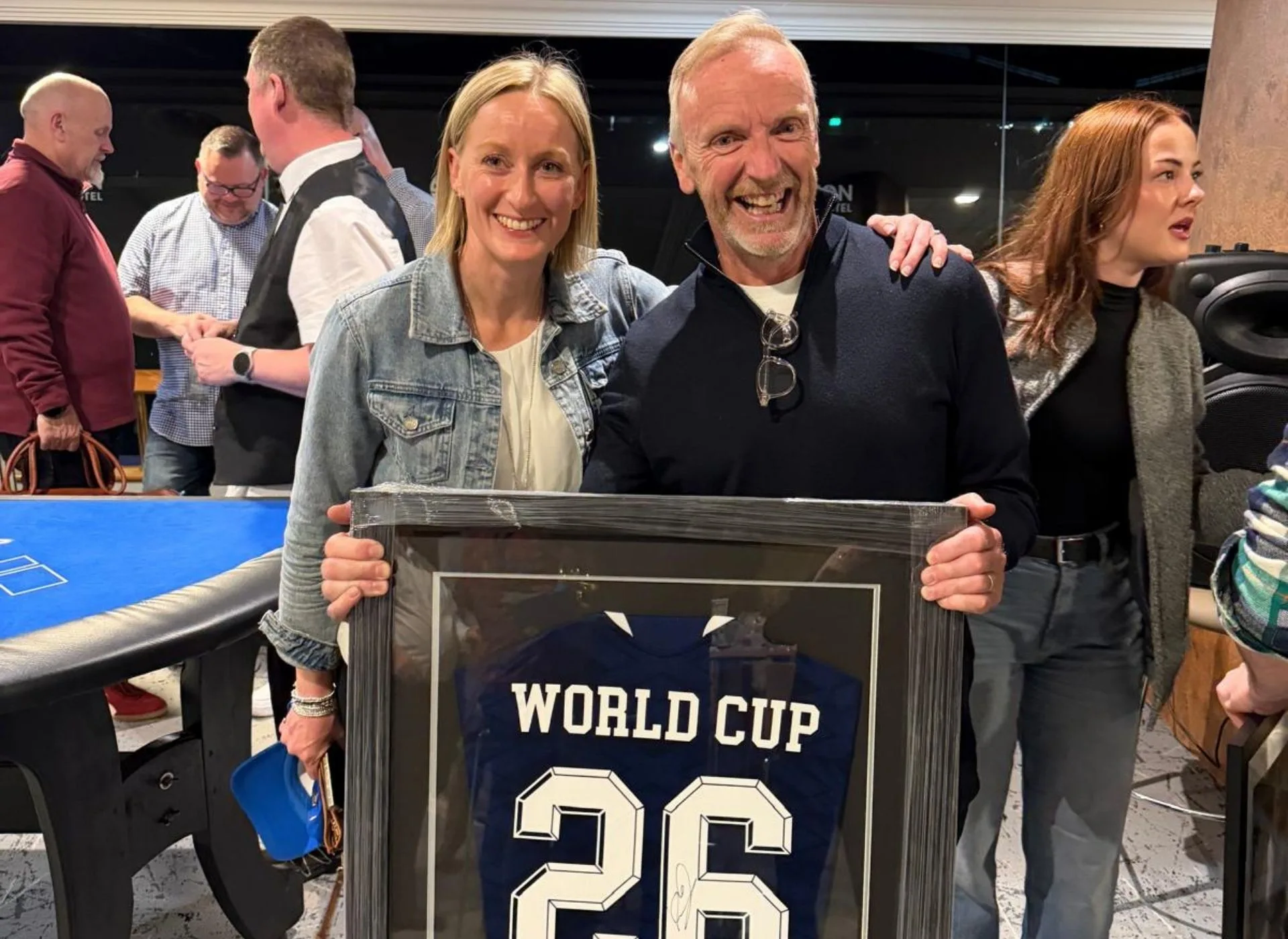 Anna with man holding world cup shirt