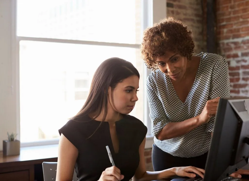 Two people working at computer