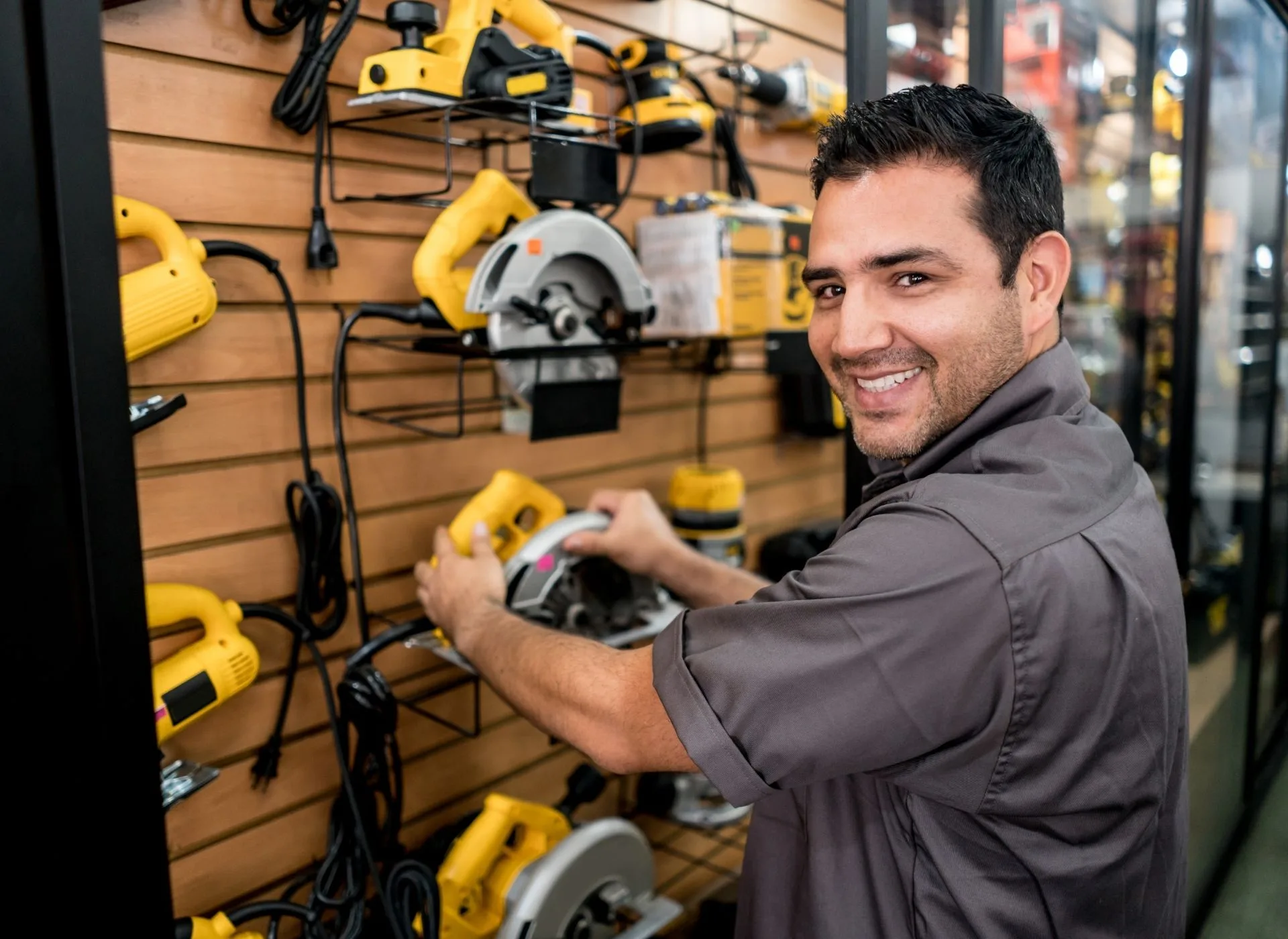 A man selecting a word tool in shop