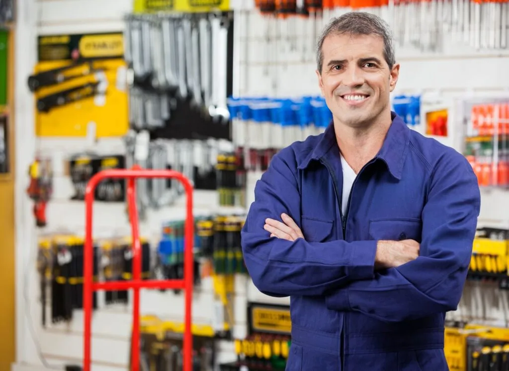 A man in overalls in tool store